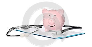 Piggy bank, stethoscope and clipboard on white background