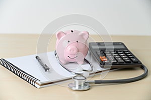 Piggy bank with stethoscope  financial checkup or saving for medical insurance costs