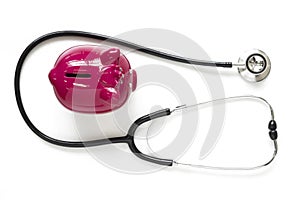 Piggy bank and stethoscope isolated