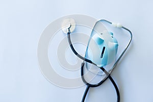 Piggy Bank and Stethoscope Isolated on a White Background.