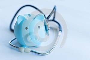 Piggy Bank and Stethoscope Isolated on a White Background.