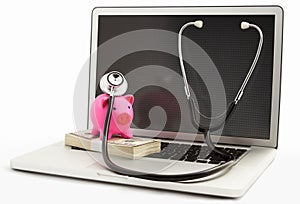 Piggy bank with stethoscope on laptop