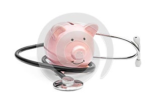 Piggy bank with stethoscope on white