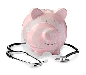 Piggy bank with stethoscope on white background. Medical insurance