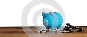 Piggy bank and stethoscope on wooden table against white background, space for text. Medical insurance