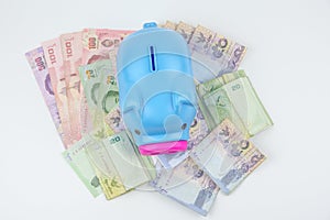 Piggy bank with THAI BATH money banknote