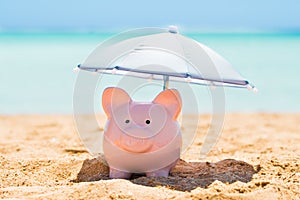Piggy Bank Under The Parasol At Beach