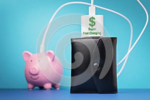 Piggy bank, wallet and smartphone charger with dollar symbol on a colored background, concept on the theme of making money