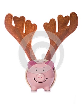 Piggy bank wearing christmas reindeer antlers cutout