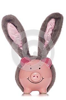 Piggy bank wearing easter rabbit ears