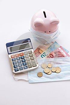 Piggy bank wearing protective face mask with euro money on white background. Money saving concept