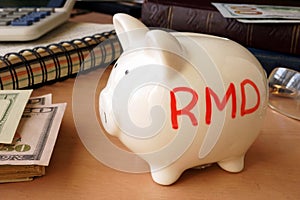 Piggy bank with word RMD. photo