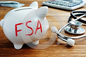 Piggy bank with letters Flexible Spending Account FSA photo