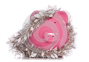 Piggy bank wrapped in Christmas tinsel