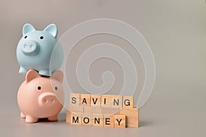 Piggy banks and alphabet letters with text SAVING MONEY