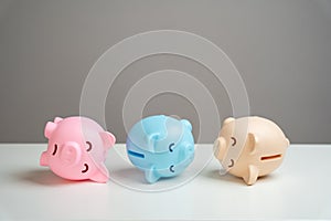 The piggy banks lie in agony. Financial crisis, end of savings, bankruptcy.