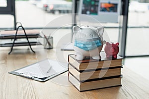 piggy banks with medical mask on