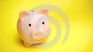 Piggy moneybox at yellow background