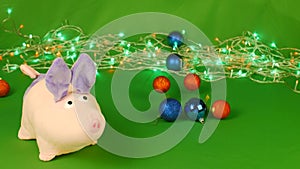 Piggy or mumps and falling Christmas decorations toys taws, New year 2019 on green Chroma key