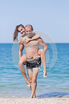 Piggyback. Guy carries girl on his back