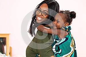 Piggyback ride with mum. Cute afican american daughter on a piggy back ride with her mother