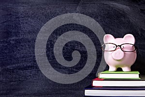 Piggybank with glasses and blackboard, copy space, back to school concept