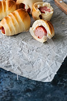 Pigs in a blanket on a baking paper. Close up. Fast food, beer s