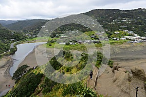 Piha black sand beach featuring cliffs and rock formations at Waitakere in New Zealand