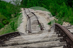 Pijana pruga or drunk railway in Istria, Croatia. A stretch of neglected railway track and bed, deformed rails, washed down by photo