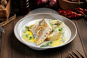 Pike perch fillet on couscous and bearnaise sauce photo