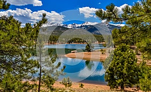 Pikes Peak panorama. Snow-capped and forested mountains near a mountain lake, Pikes Peak Mountains in Colorado Spring, Colorado