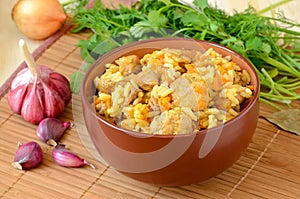 Pilaf in a brown bowl and vegetables