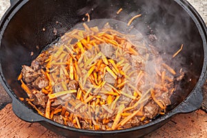 Pilaf, pilaw, plov, rice with meat in pan. Cooking process
