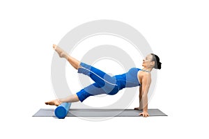 Pilates, core and glutes training. Fit caucasian woman in blue sportswear practice reverse plank drill with foam roller