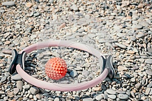 Pilates magic ring and rubber band on yoga mat near sea. Female fitness yoga concept. Healthy lifestyle harmony and