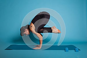 Pilates person standing in hands on yoga mat stretching exercises