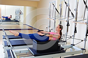 Pilates reformer woman back stroke exercise photo