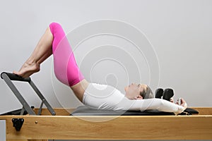 Pilates reformer woman gym fitness teacher legs photo