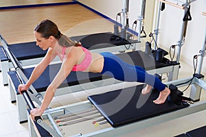 Pilates reformer woman long stretch exercise