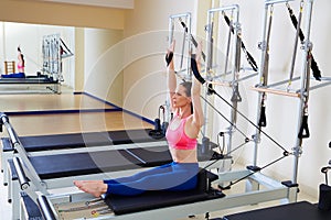 Pilates reformer woman rowing row exercise