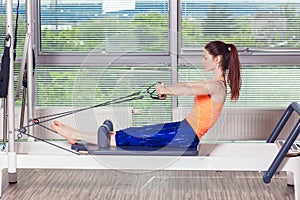 Pilates reformer workout exercises woman at gym indoor