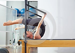 Pilates woman in reformer roll over exercise photo