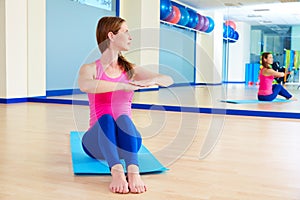 Pilates woman spine twist exercise workout at gym