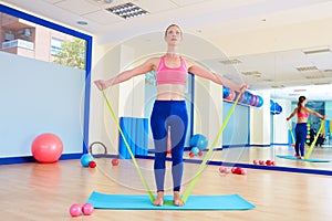 Pilates woman standing rubber band exercise