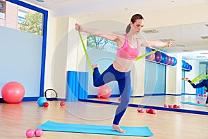 Pilates woman standing rubber band exercise