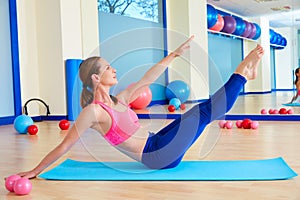 Pilates woman teaser exercise workout at gym