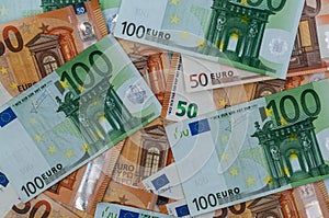 Pile of 100 and 50 euro banknotes