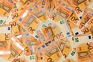 Pile of 50 real euro banknotes isolated on a black background