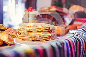 Pile of air pancakes on a wooden dinette, a traditional food family. pancakes of golden color