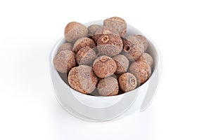 Pile Allspice in a bowl on white background.